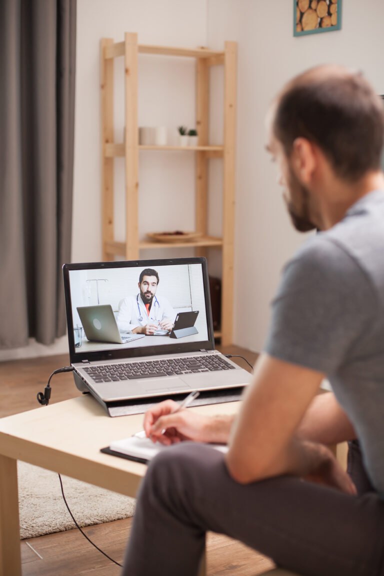 A man having a video consultation with a doctor from home, representing a conversation with a licensed provider.